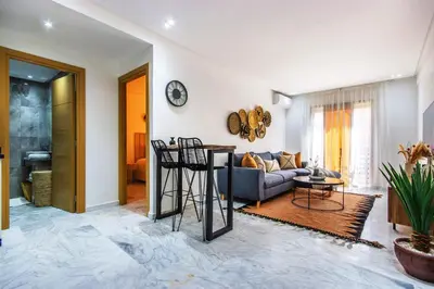 a living room with a couch and a table at Bohemian Style in hyper-center - Wifi in Marrakech