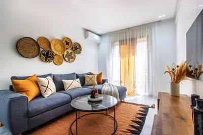 a living room with a blue couch and a table at Bohemian Style in hyper-center - Wifi in Marrakech