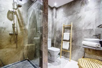 a bathroom with a shower and a toilet and a sink at Bohemian Style in hyper-center - Wifi in Marrakech
