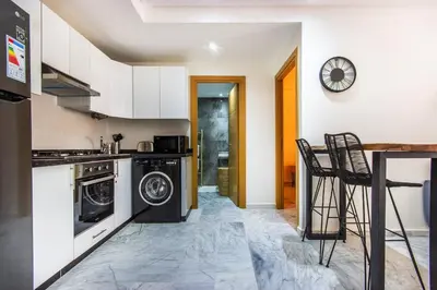 a kitchen with a washer and dryer in it at Bohemian Style in hyper-center - Wifi in Marrakech