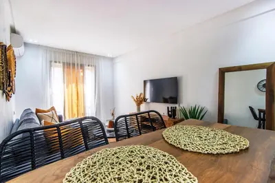 a dining room with a table with chairs and a couch at Bohemian Style in hyper-center - Wifi in Marrakech