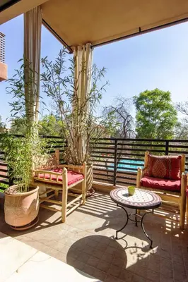 a patio with two couches and a table at Sumptuous appart Heart of Hivernage - Pool in Marrakech