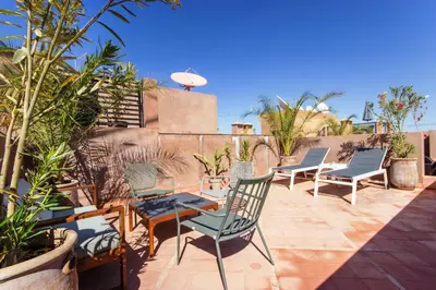 a patio with chairs and a table on a patio at Sumptuous appart Heart of Hivernage - Pool in Marrakech
