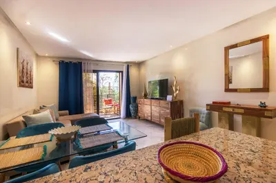 a living room with a table and a couch at Sumptuous appart Heart of Hivernage - Pool in Marrakech