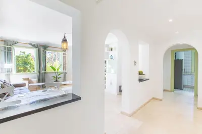 two views of a living room with white walls at Romantic Retreat next to M avenue in Marrakech