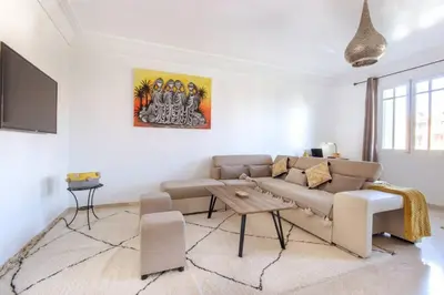a living room with a couch and a table at Super cosy fully equip - pool - prox. M Avenue in Marrakech