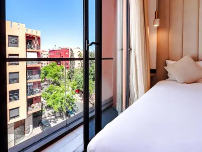 a bedroom with a bed and a large window at Style et Comfortable au Centre de la Ville in Marrakech