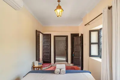 a bedroom with a bed with two towels on it at Riad Akasia in Marrakech