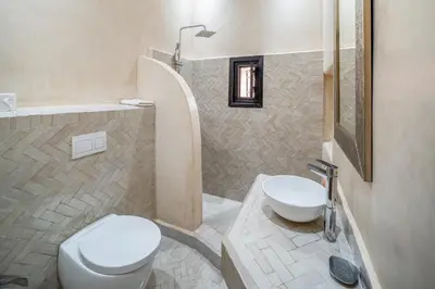 a bathroom with a toilet and a sink at Riad Akasia in Marrakech