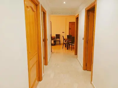 a hallway leading to a room with a dining room at Family Apartment with Pool in Marrakech