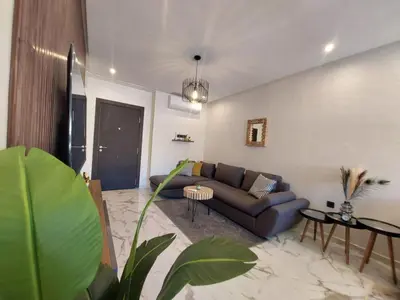 a living room with a couch and a table at Palm Appart in Marrakech