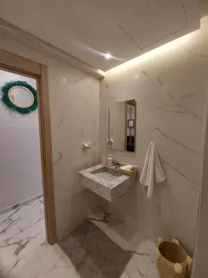 a bathroom with a sink and a mirror at Palm Appart in Marrakech