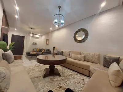 a living room with a couch and a table at Palm Appart in Marrakech
