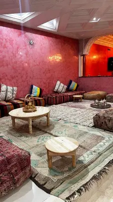 a living room with a couch and a table at Riad Jasmine SYBA in Marrakech