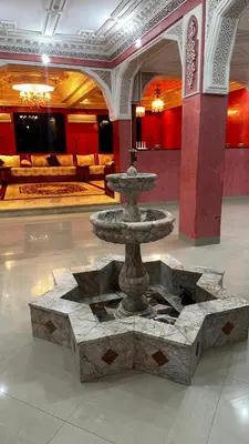 a fountain in the middle of a room at Riad Jasmine SYBA in Marrakech