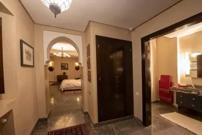 a hallway with a room with a bed and a mirror at Exceptional villa on 10,000 meter square with heated pool in Marrakech