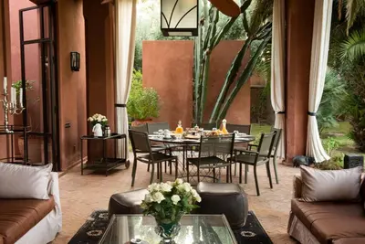 a dining room with a table and chairs at Exceptional villa on 10,000 meter square with heated pool in Marrakech
