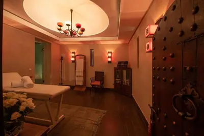 a living room with a bed and a chandelier at Exceptional villa on 10,000 meter square with heated pool in Marrakech