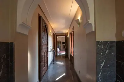 a hallway with an archway in a house at Exceptional villa on 10,000 meter square with heated pool in Marrakech