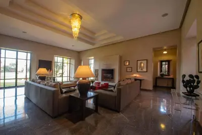 a large living room with couches and a fireplace at Exceptional villa on 10,000 meter square with heated pool in Marrakech