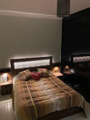 a bedroom with a large bed with two red shoes on it at appartement in Marrakech