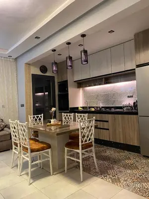 a kitchen with a table and chairs in a room at appartement in Marrakech