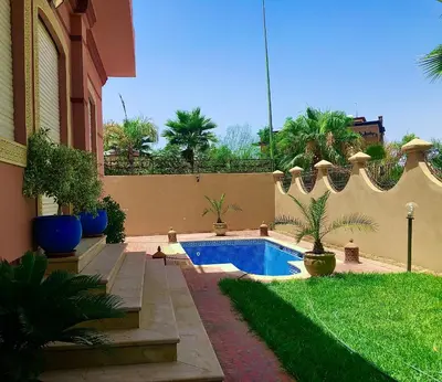 a backyard with a swimming pool and a fence at Villa La Baraka in Marrakech