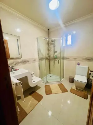 a bathroom with a shower and a sink and a toilet at Villa La Baraka in Marrakech
