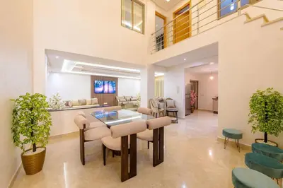 a living room with a table and chairs at Charming City Getaway in Marrakech