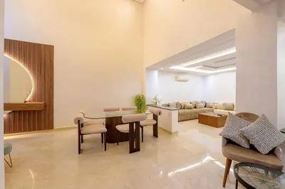 a living room with a table and chairs and a couch at Charming City Getaway in Marrakech