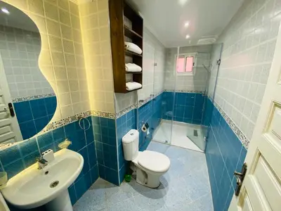 a bathroom with a toilet and a sink at Appart Moderne Calme & Climatisé in Marrakech