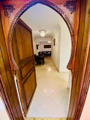 an archway leading into a dining room through a door at Appart Moderne Calme & Climatisé in Marrakech