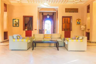 a living room with two couches and a coffee table at Villa 36 Amelkis - Pool & Garden in Marrakech