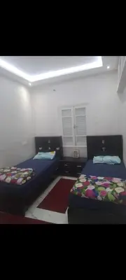 a room with two beds in a room at Qortoba house in Marrakech