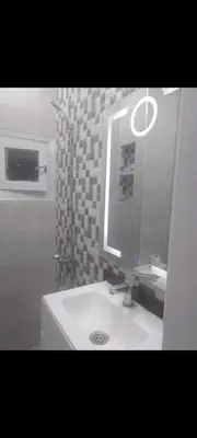 a bathroom with a white sink and a mirror at Qortoba house in Marrakech