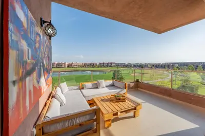 a balcony with a couch and a table at Luxury and serenity in Prestigia Golf & Pool in Marrakech
