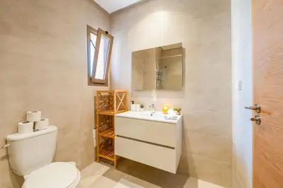 a bathroom with a toilet and a sink at Luxury and serenity in Prestigia Golf & Pool in Marrakech