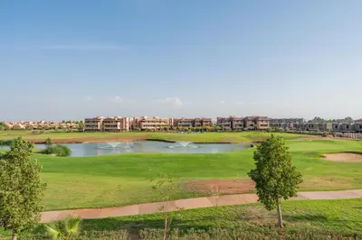an aerial view of a golf course with a pond at Luxury and serenity in Prestigia Golf & Pool in Marrakech