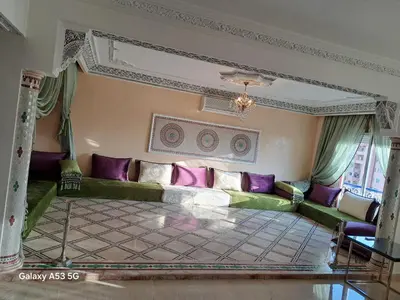 a living room with a green couch and purple pillows at Élégance et authenticité in Marrakech