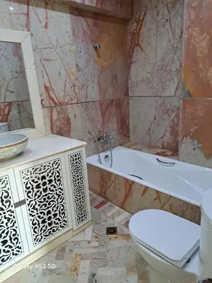 a bathroom with a tub and a toilet and a sink at Élégance et authenticité in Marrakech