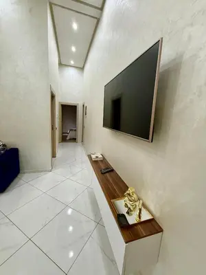 a living room with a flat screen tv on a wall at Appartement sympathique in Marrakech