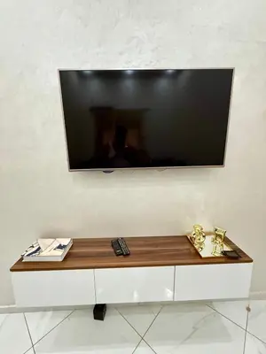 a flat screen tv on a white wall at Appartement sympathique in Marrakech