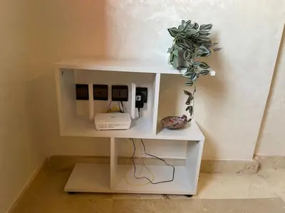 a white shelf with a phone and a plant on it at La maison Majorelle de Marrakech in Marrakech