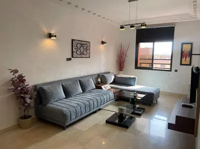 a living room with a couch and a table at La maison Majorelle de Marrakech in Marrakech