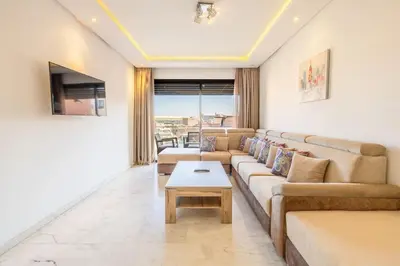 a living room with a couch and a table at Appartement haut standing au centre de Marrakech in Marrakech