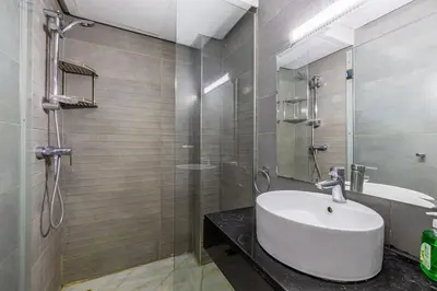 a bathroom with a sink and a glass shower at Appartement haut standing au centre de Marrakech in Marrakech