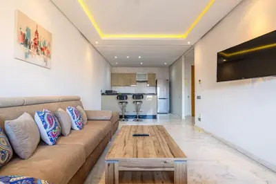 a living room with a couch and a coffee table at Appartement haut standing au centre de Marrakech in Marrakech