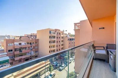 a balcony with a view of a city at Appartement haut standing au centre de Marrakech in Marrakech