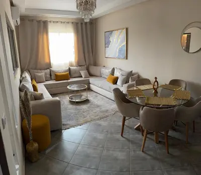 a living room with a couch and a table at Le Marrakchi - 2 chambres - Parking - Wifi in Marrakech