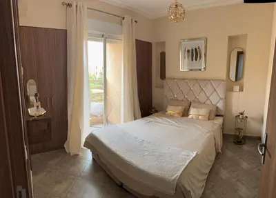 a bedroom with a bed and a large window at Le Marrakchi - 2 chambres - Parking - Wifi in Marrakech